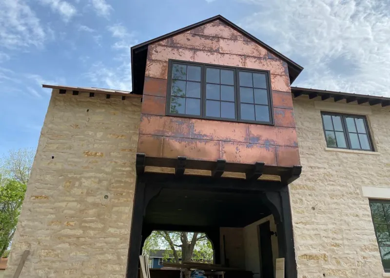 Copper metal panel facade on a stone building for Roof Repair in Palmetto
